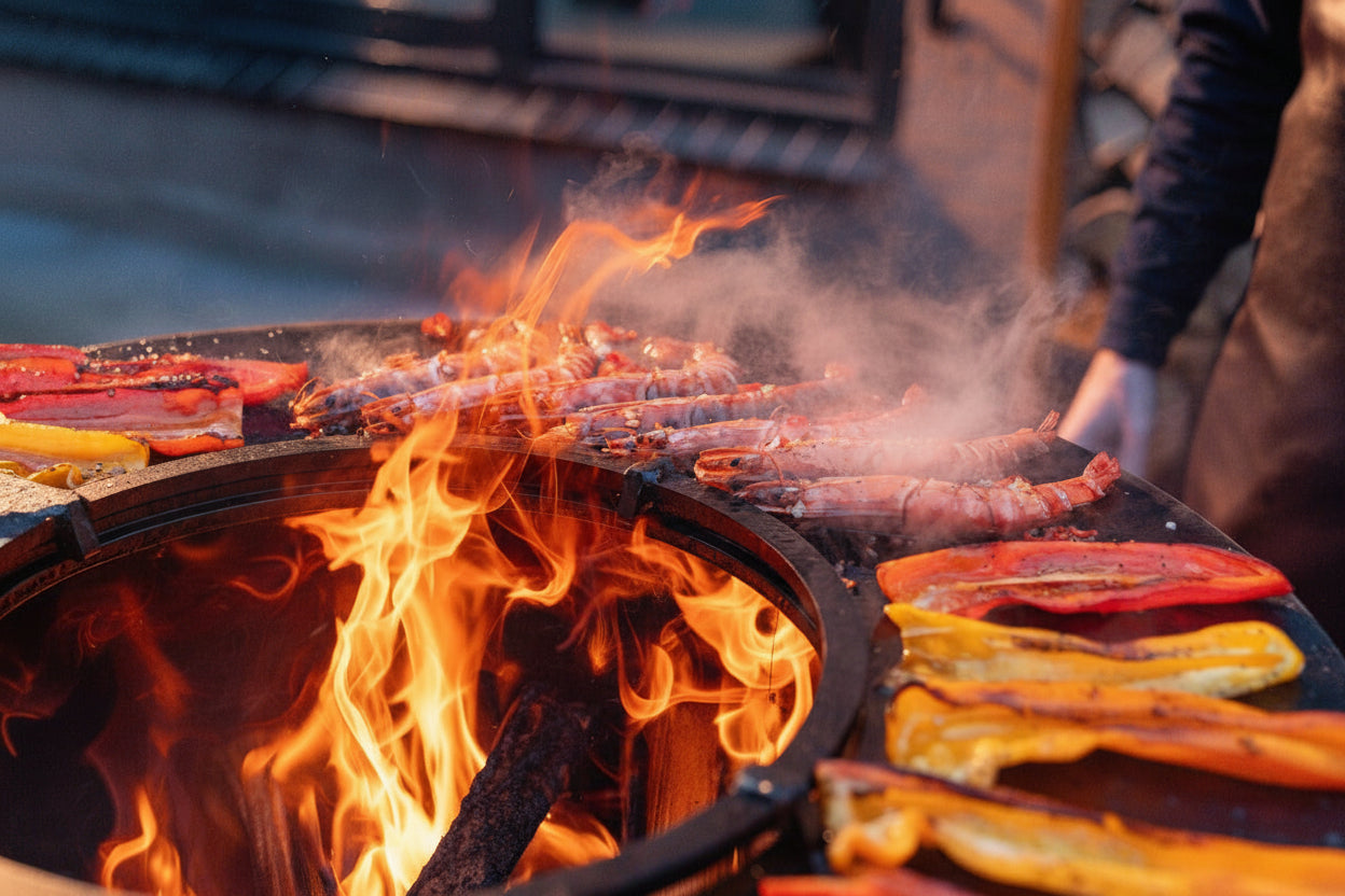 Grilling vegetables and sausages over an open flame on a barbecue.