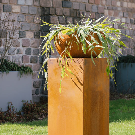 Corten steel plinth with Corten onyx planter on top in contemporary garden setting