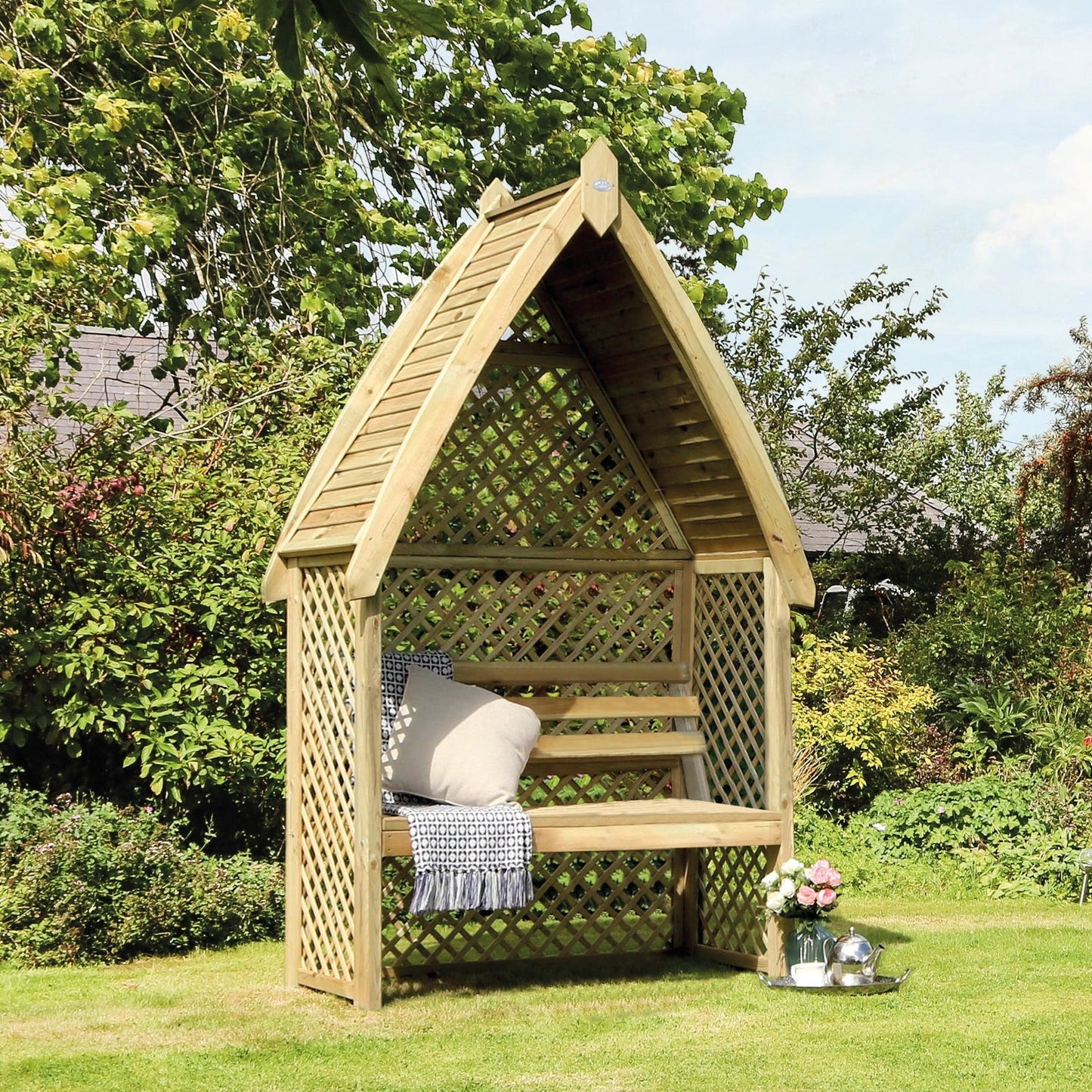 A Chepstow arbour surrounded by greenery, offering a charming seating area in the garden.